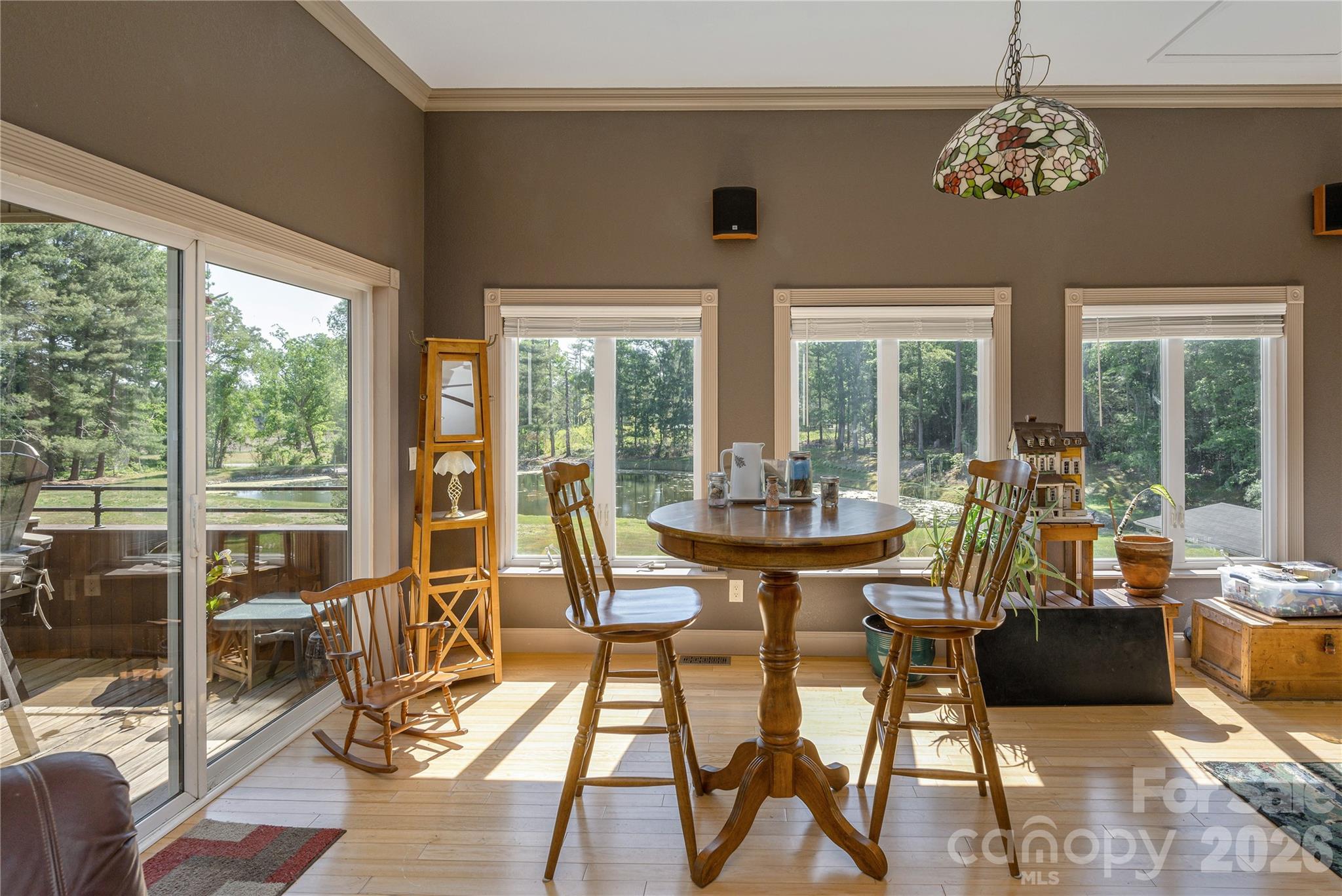 231 Allen Road East Flat Rock, NC 28726 - Photo 16 of 42 a view of a dining room with furniture large windows and wooden floor