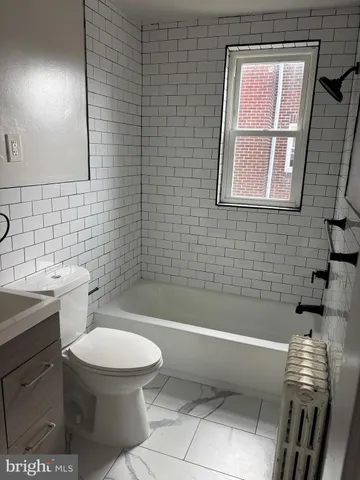 a bathroom with a toilet a sink and bathtub