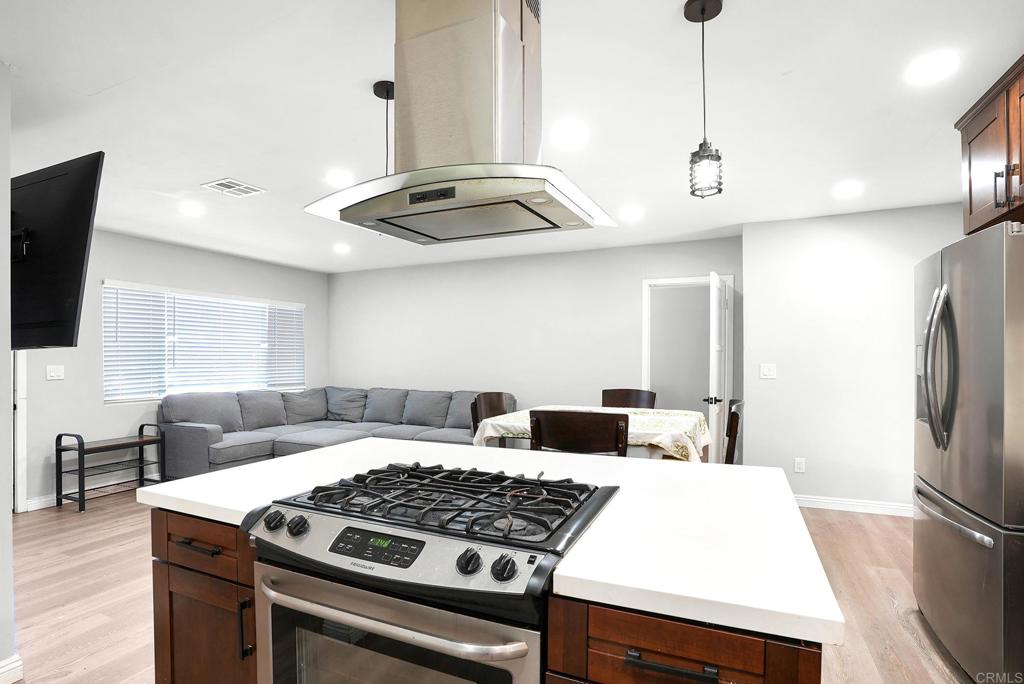 3581 Trophy Drive La Mesa, CA 91941 - Photo 3 of 22 a kitchen with stainless steel appliances granite countertop a sink a stove and a refrigerator