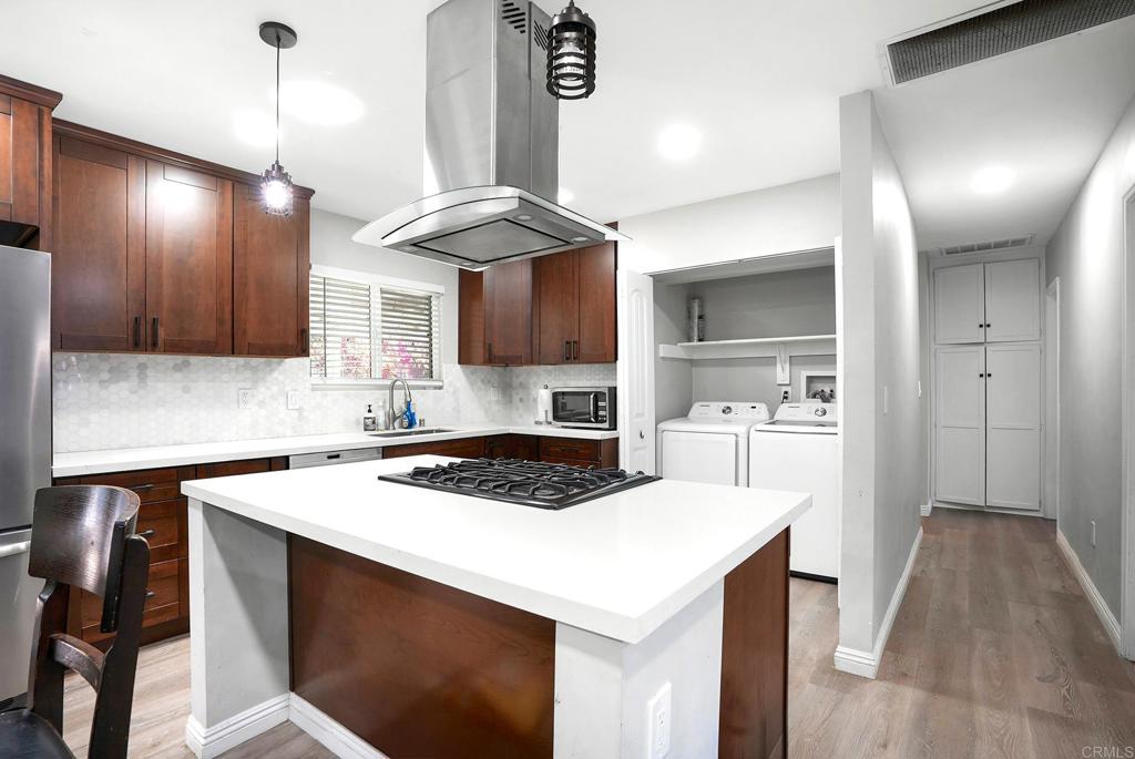 3581 Trophy Drive La Mesa, CA 91941 - Photo 4 of 22 a kitchen with a sink a stove a refrigerator and cabinets