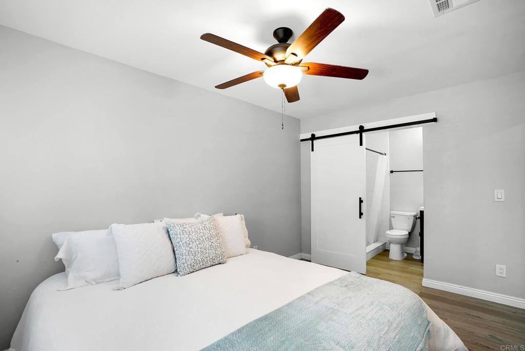 3581 Trophy Drive La Mesa, CA 91941 - Photo 9 of 22 a bedroom with a large bed and a ceiling fan