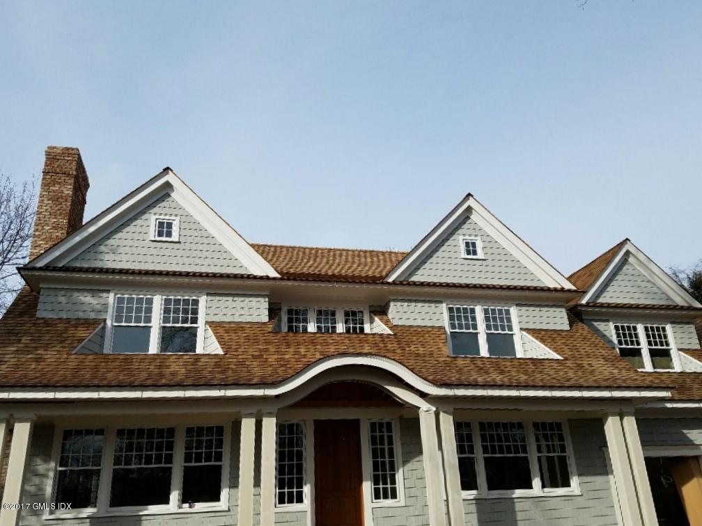 55 Hidden Brook Road Riverside, CT 06878 - Photo 2 of 2 a front view of a house with a yard
