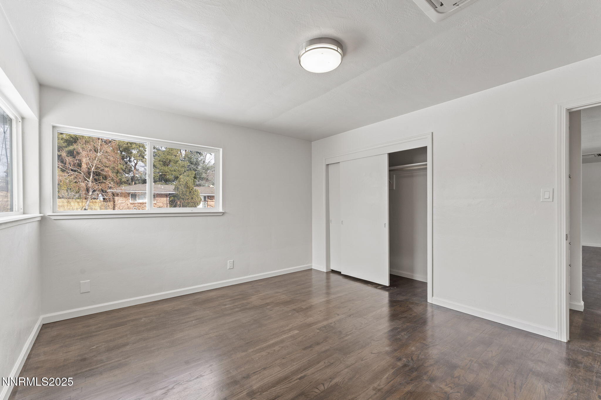 840 Brookfield Drive Reno, NV 89503 - Photo 18 of 42 an empty room with wooden floor and window