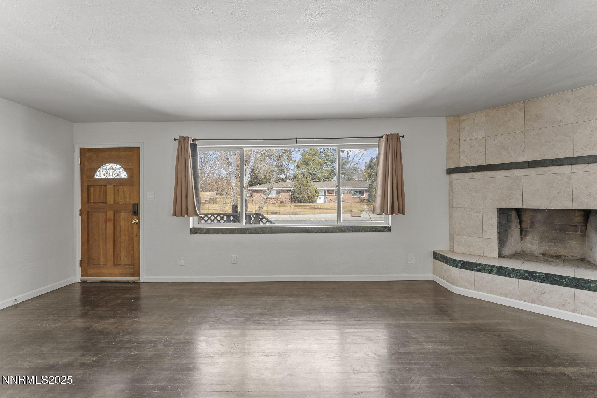840 Brookfield Drive Reno, NV 89503 - Photo 9 of 42 an empty room with windows and fireplace