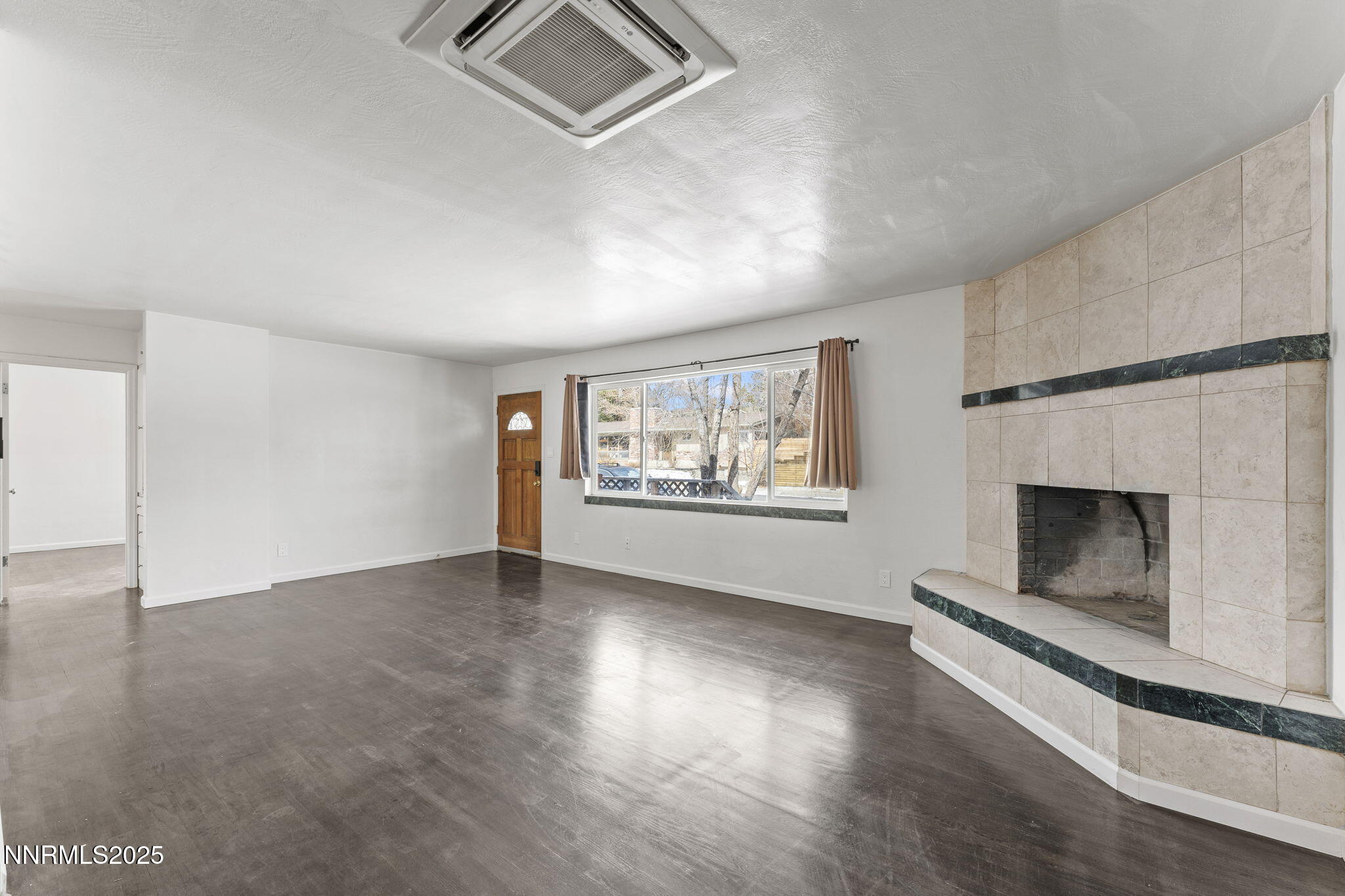 840 Brookfield Drive Reno, NV 89503 - Photo 10 of 42 an empty room with windows and fireplace