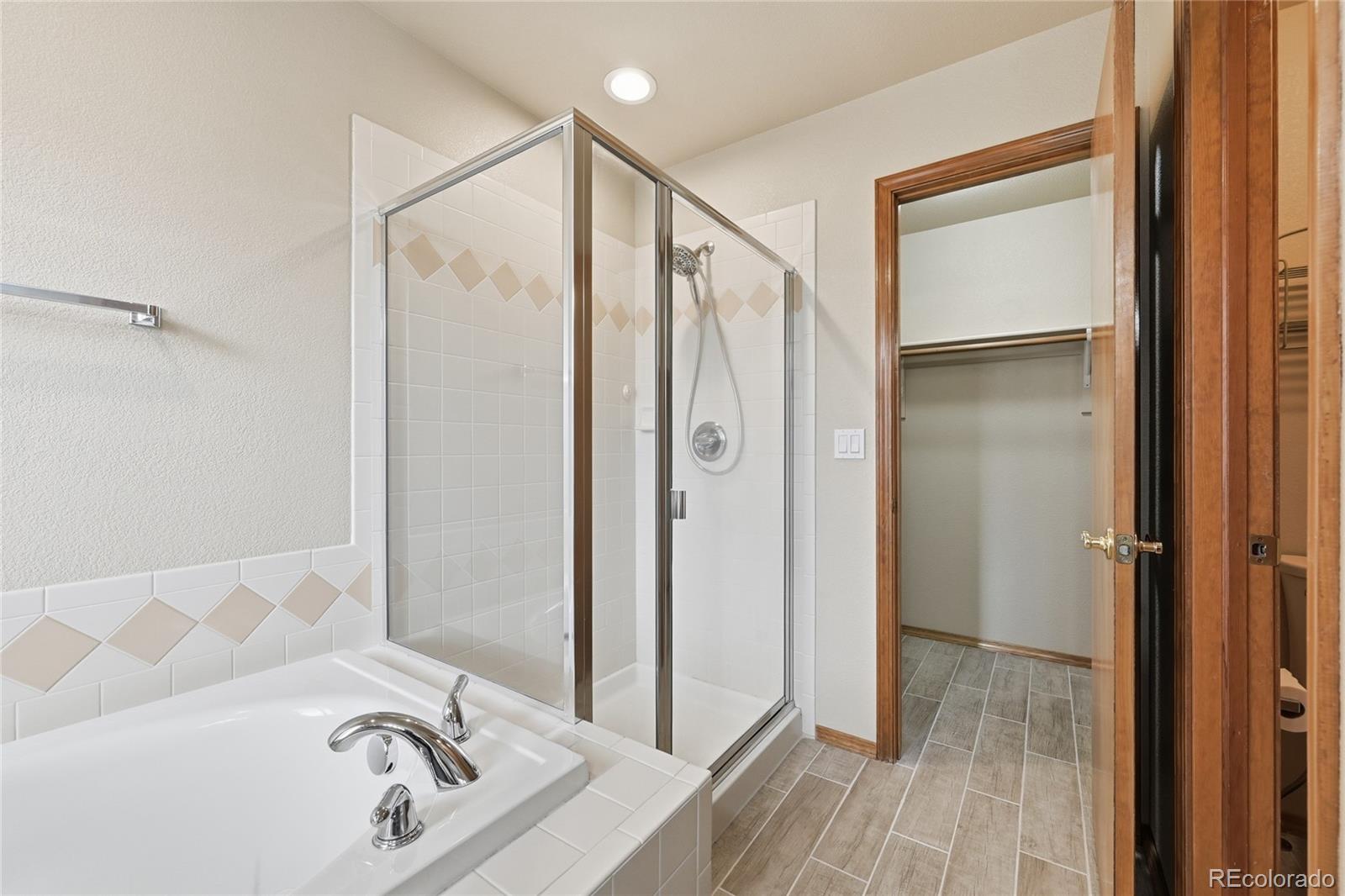 9288 Rockingham Drive Peyton, CO 80831 - Photo 19 of 49 a bathroom with a tub and shower
