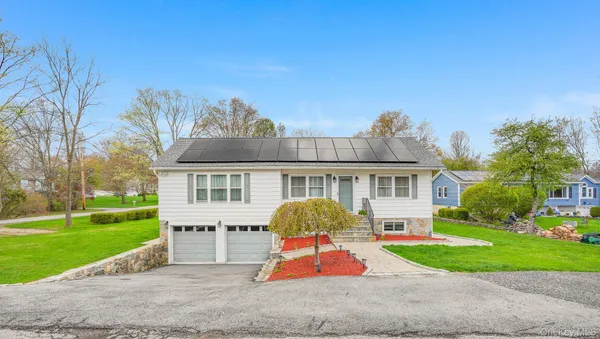 a front view of house with yard and green space