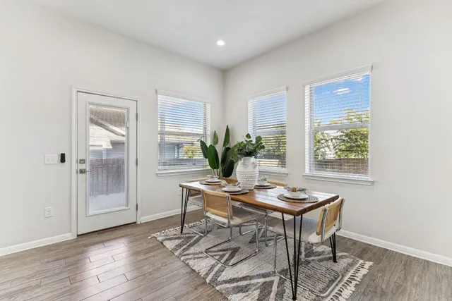 a view of a workspace room with furniture and window