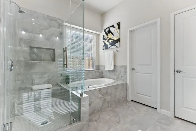 a spacious bathroom with a granite countertop sink a toilet and shower