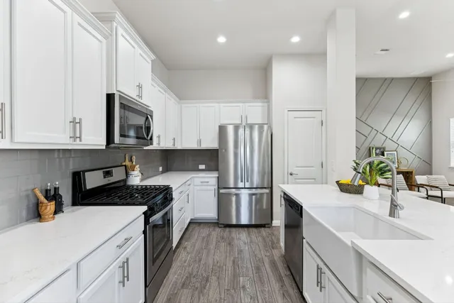 a kitchen with a sink a stove and cabinets