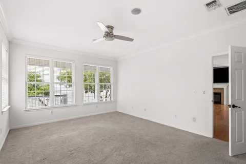 a view of a livingroom with a ceiling fan and window