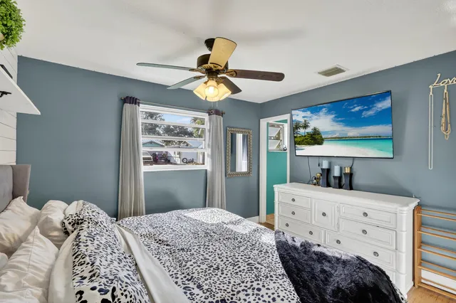 a bedroom with a bed and a chandelier