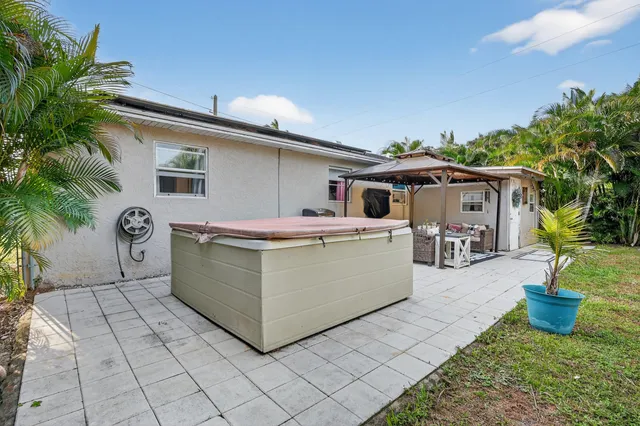 a backyard of a house with plants and trees