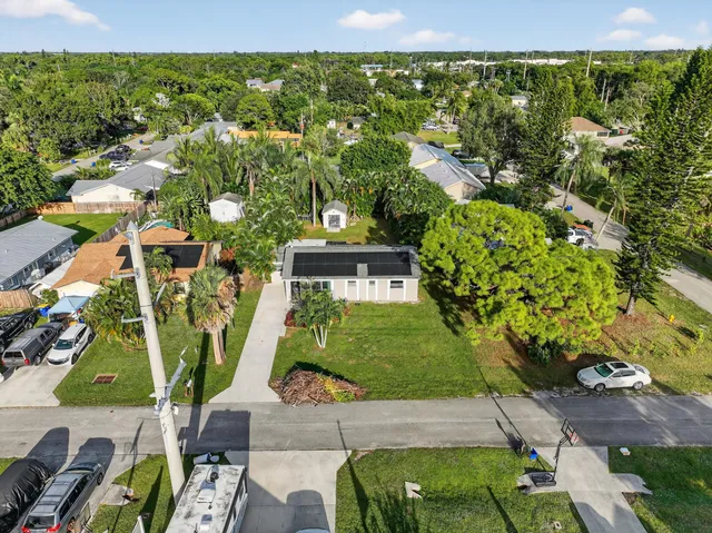 an aerial view of residential houses with outdoor space