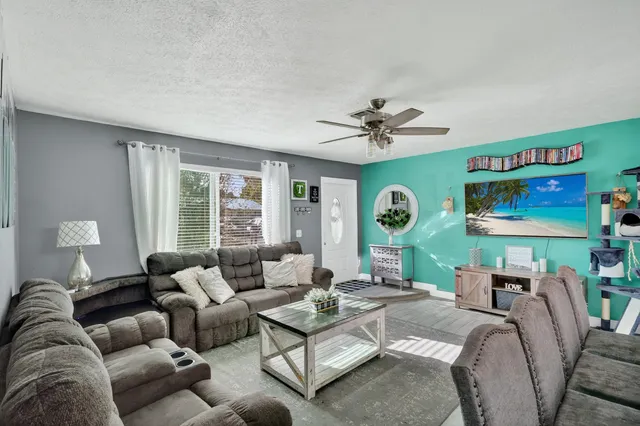 a living room with furniture and a large window