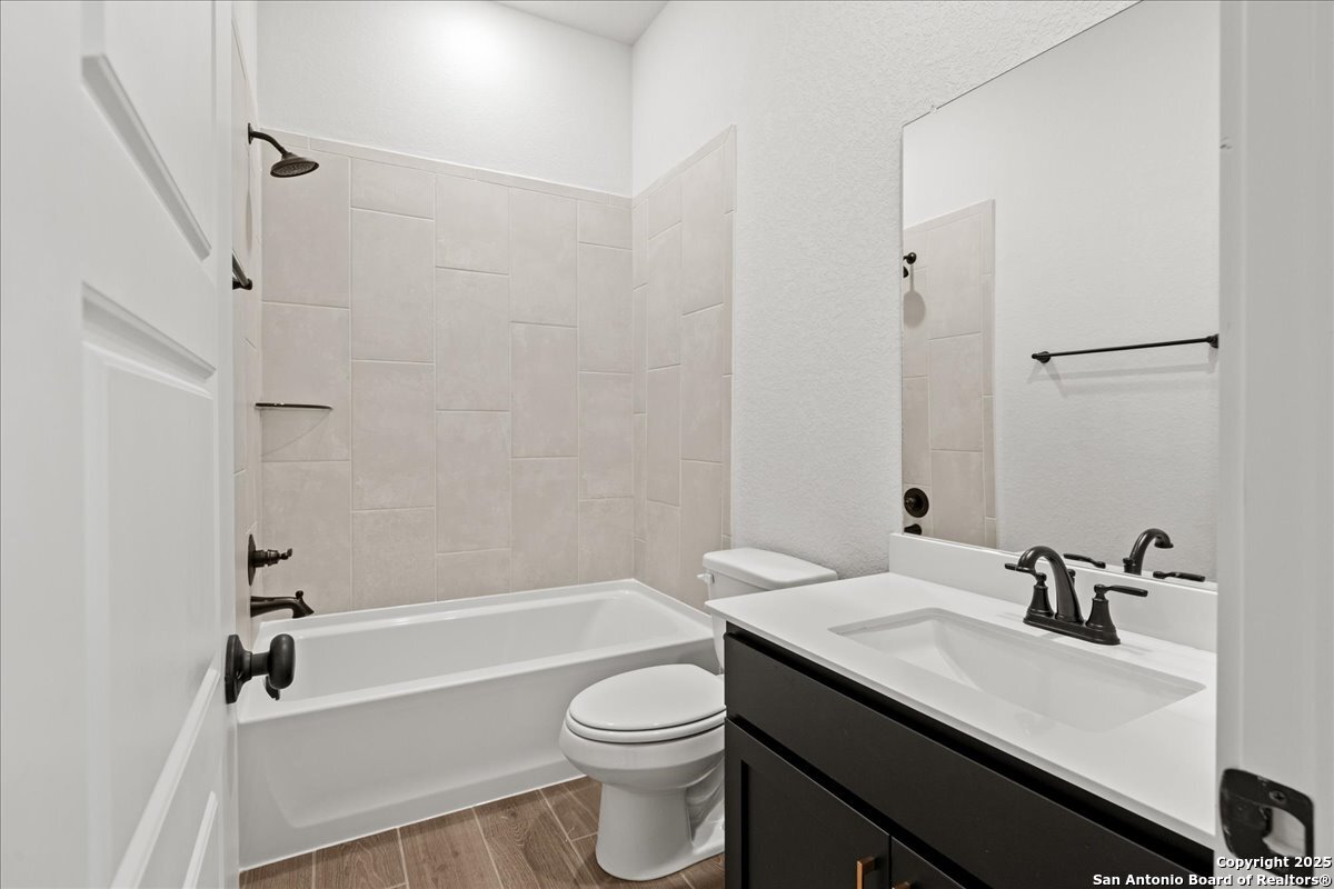 2134 Shepards Street Seguin, TX 78155 - Photo 12 of 24 a bathroom with a granite countertop sink toilet and shower