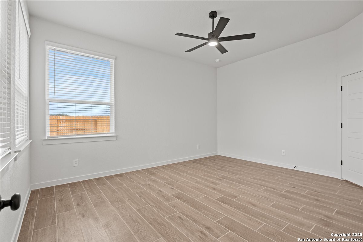 2134 Shepards Street Seguin, TX 78155 - Photo 13 of 24 a view of a room with wooden floor and a ceiling fan