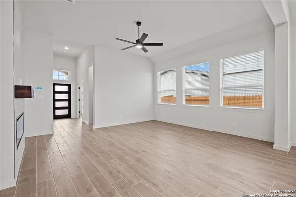 wooden floor in an empty room with a window