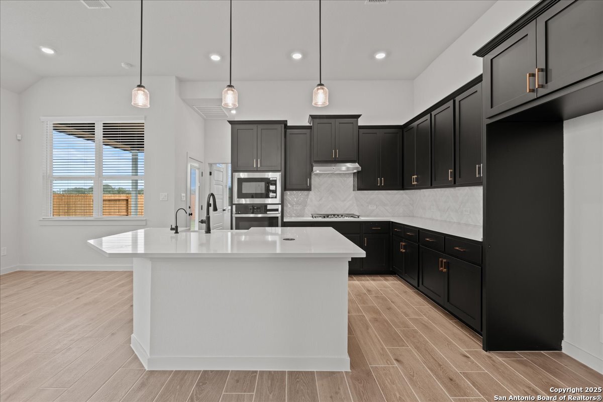2134 Shepards Street Seguin, TX 78155 - Photo 5 of 24 a large kitchen with stainless steel appliances kitchen island a large island in the center