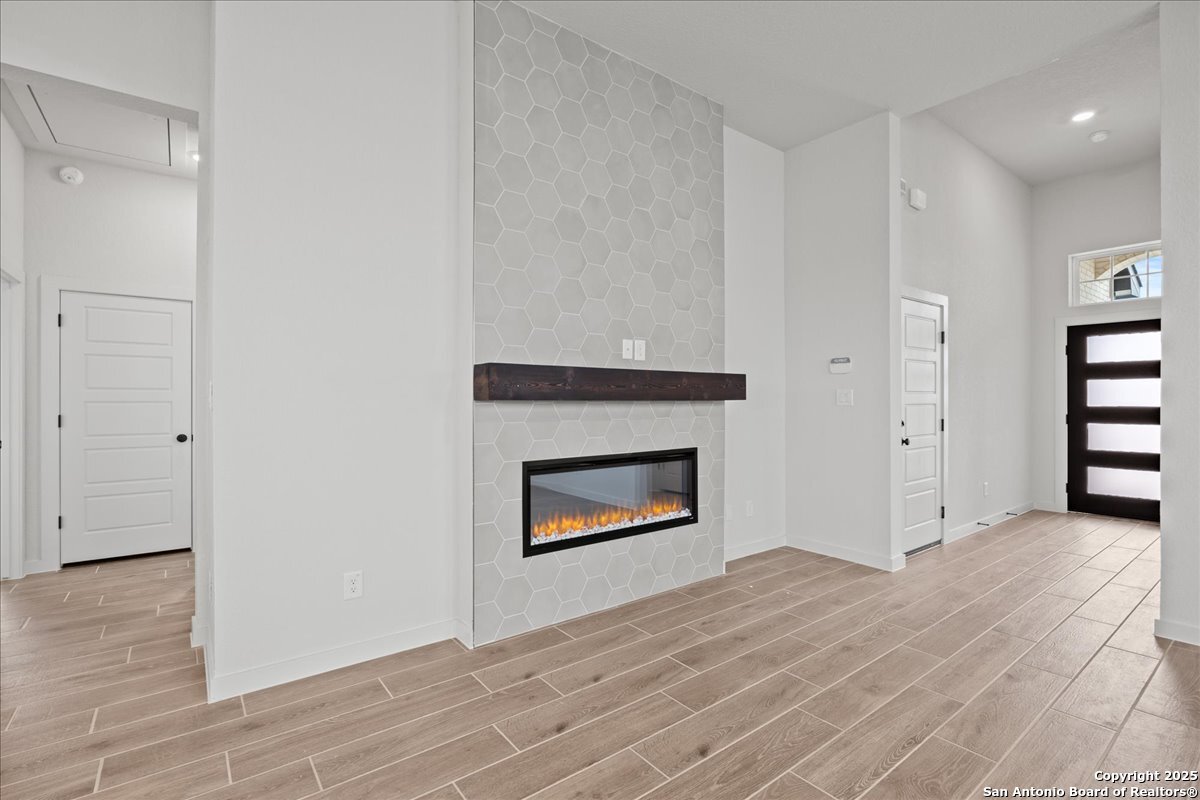 2134 Shepards Street Seguin, TX 78155 - Photo 9 of 24 a view of an empty room with wooden floor and a fireplace