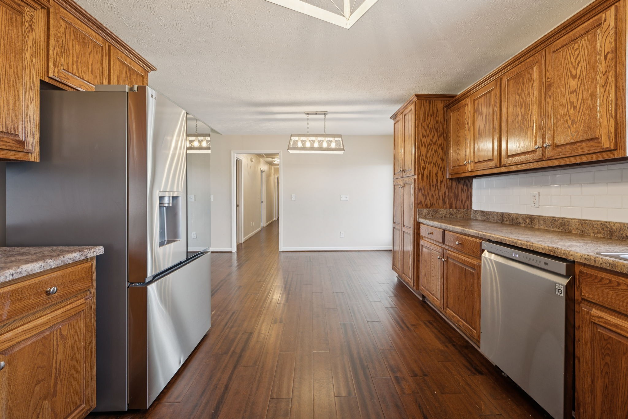 800 Williams Road Lafayette, TN 37083 - Photo 11 of 49 a kitchen with stainless steel appliances granite countertop a refrigerator and a stove top oven