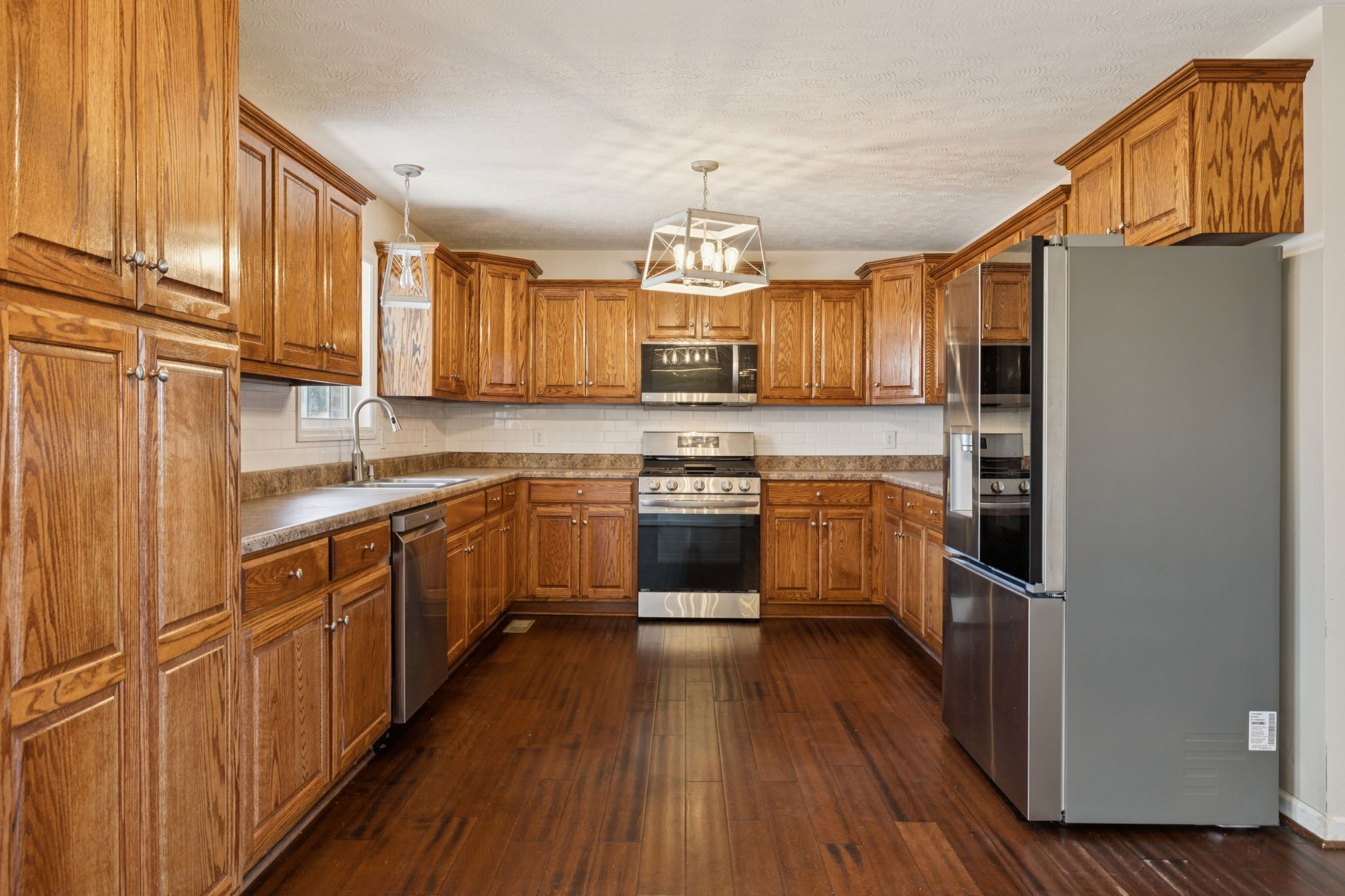 800 Williams Road Lafayette, TN 37083 - Photo 8 of 49 a kitchen with stainless steel appliances a refrigerator sink and cabinets