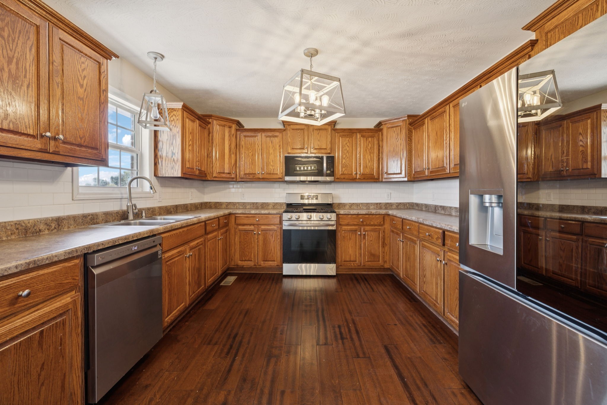 800 Williams Road Lafayette, TN 37083 - Photo 10 of 49 a kitchen with stainless steel appliances granite countertop wooden cabinets a sink dishwasher a stove and a refrigerator