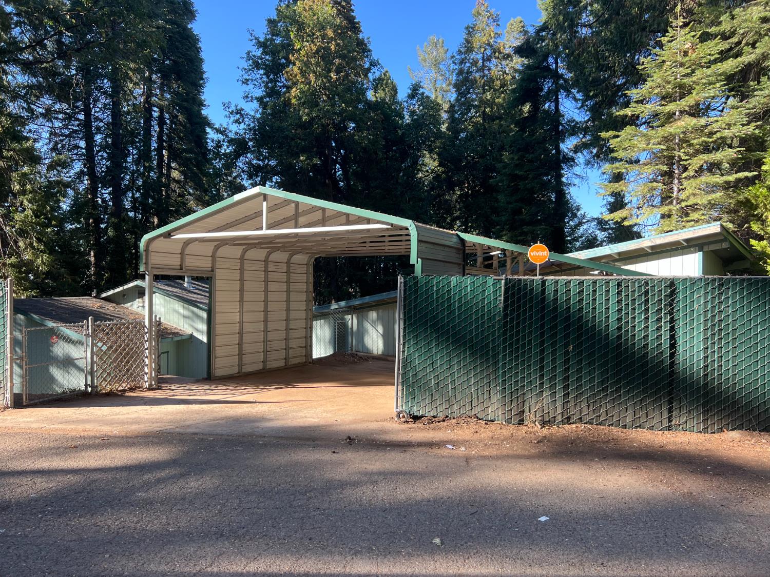 a view of a small house with large trees