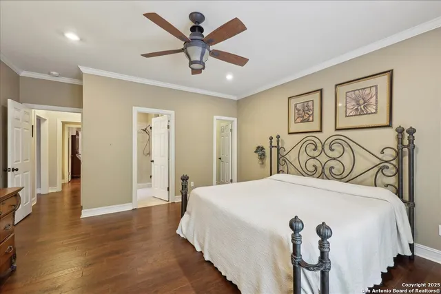 a bedroom with a large bed and a chandelier