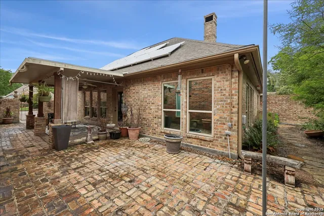 a front view of a house with outdoor seating and a potted plant