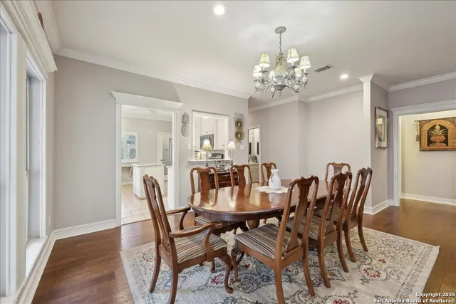 a view of a dining room with furniture and chandelier