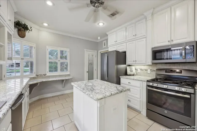 a kitchen with a stove a sink and a refrigerator