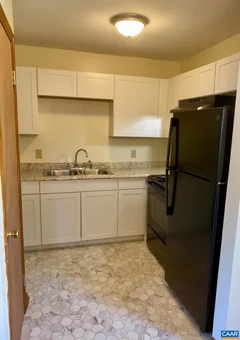a kitchen with a sink stove and refrigerator
