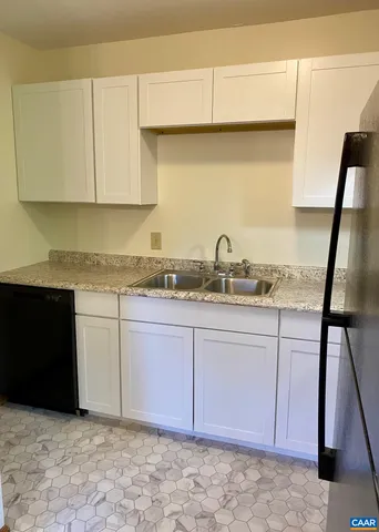 a kitchen with granite countertop a sink a stove and a microwave