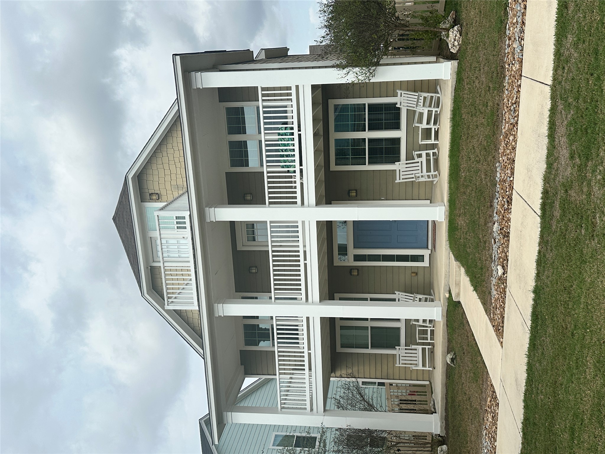 View of front facade with a porch and a front lawn