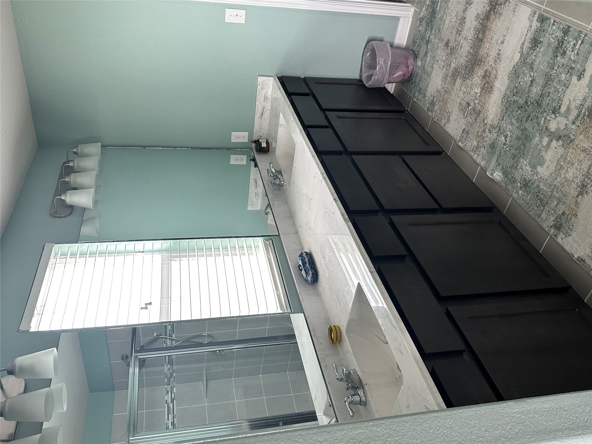 1269 Nevarez Kyle, TX 78640 - Photo 13 of 27 Full bathroom with double vanity, dark tile patterned floors, and a shower stall