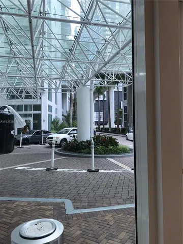 a view of a room with a chandelier and potted plant