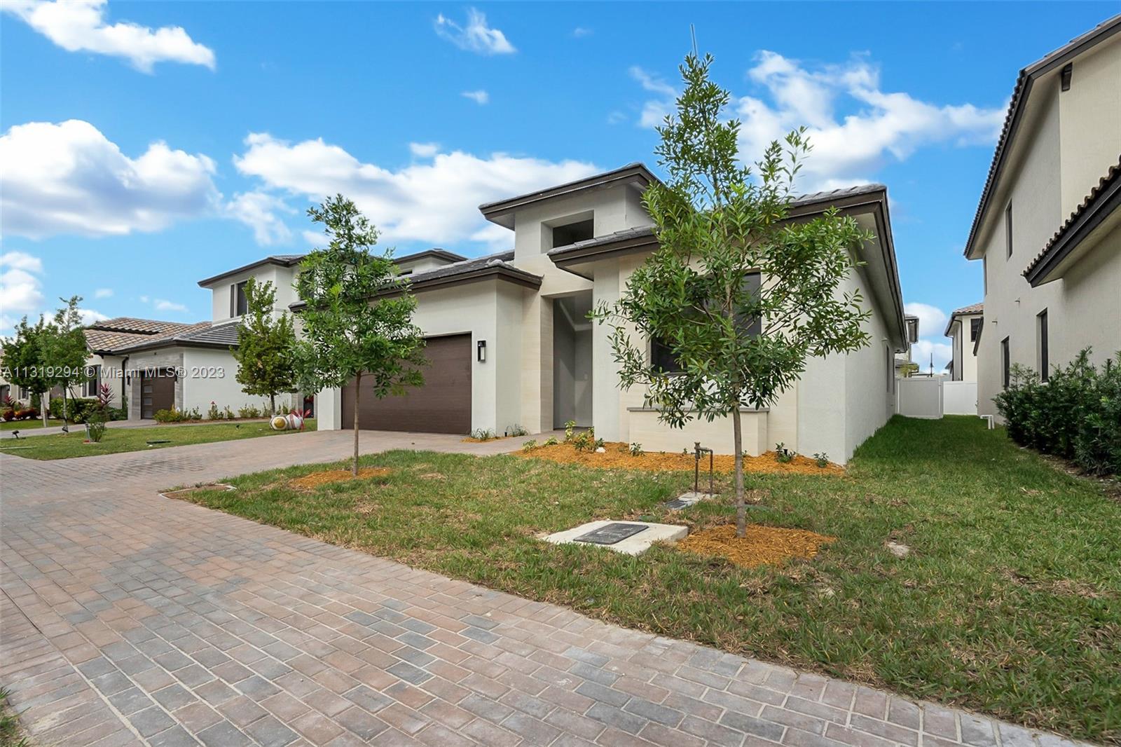a front view of a house with a yard and garage
