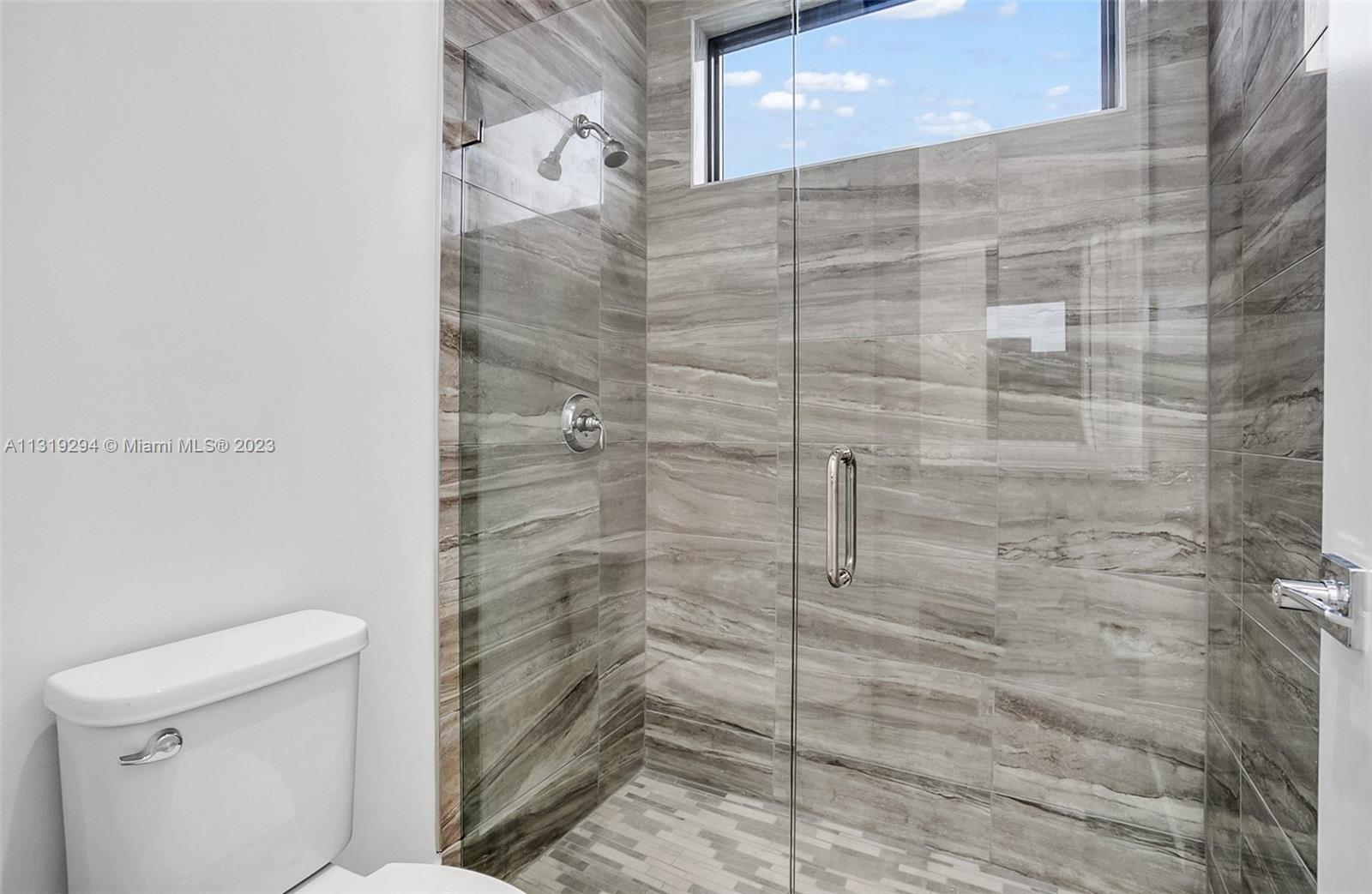Doral Doral, FL 33166 - Photo 15 of 42 a bathroom with a shower and a toilet