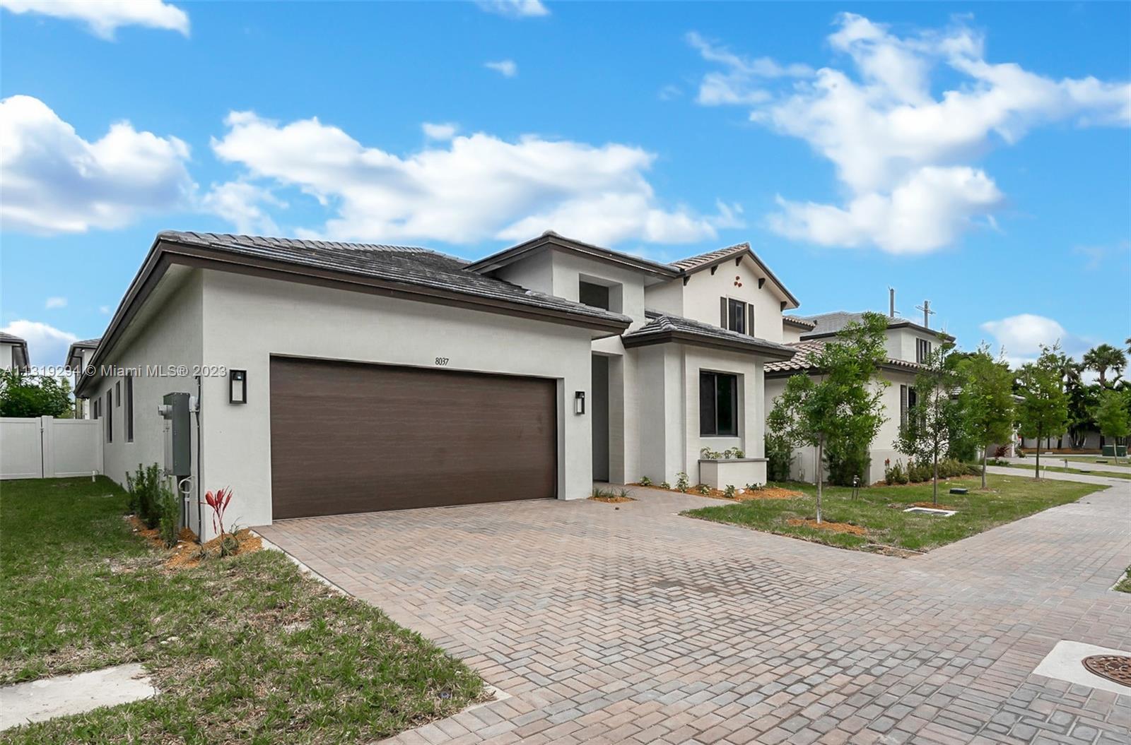 Doral Doral, FL 33166 - Photo 2 of 42 a front view of a house with a yard and garage