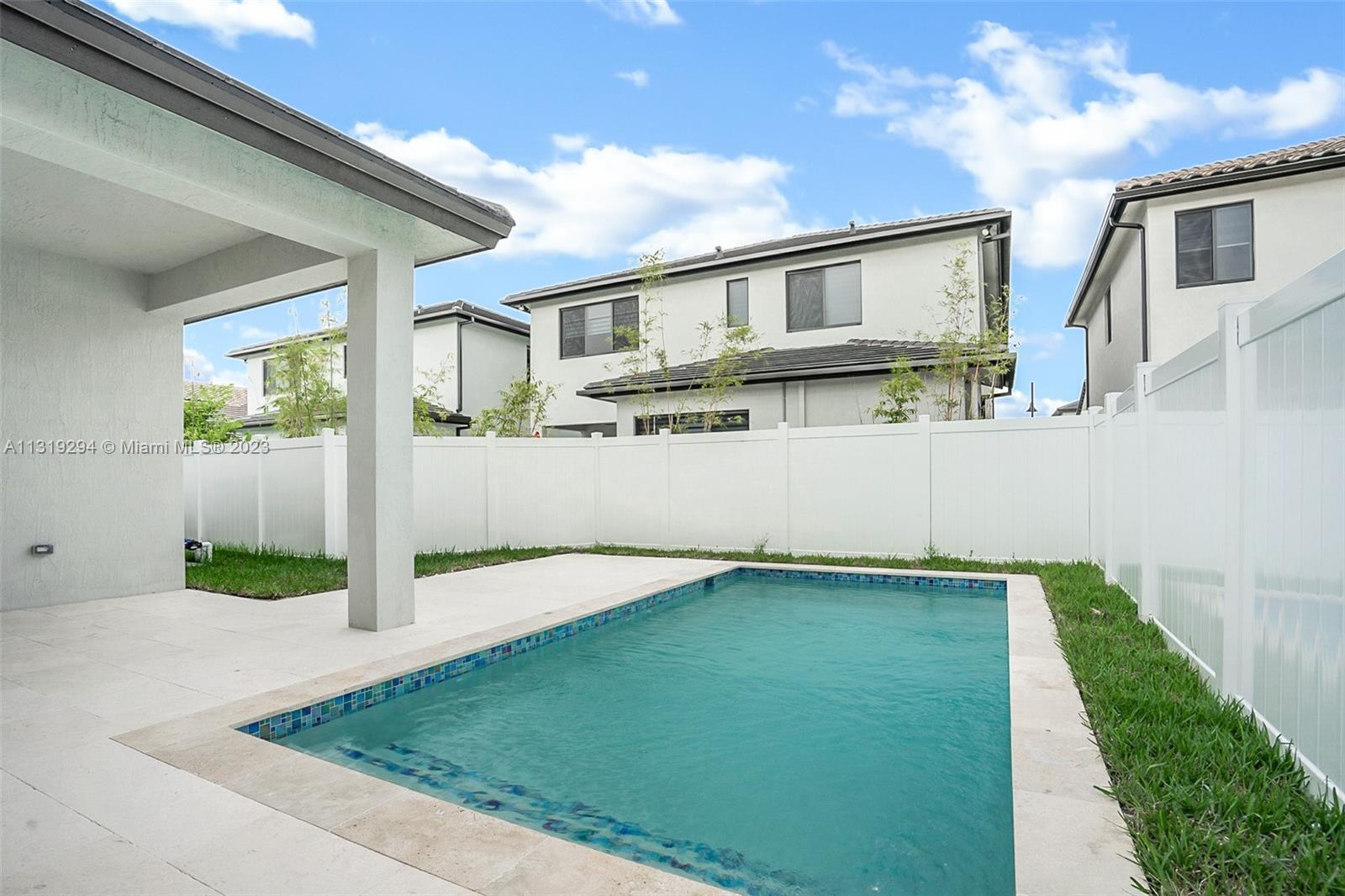Doral Doral, FL 33166 - Photo 22 of 42 a front view of a house with a yard