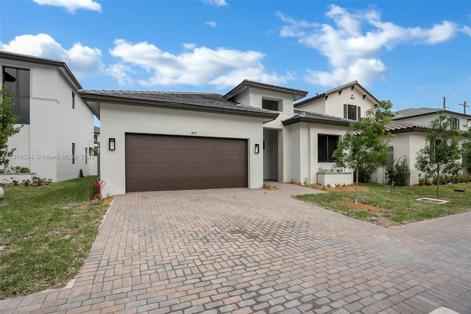 Doral Doral, FL 33166 - Photo 3 of 42 a front view of a house with a yard and garage
