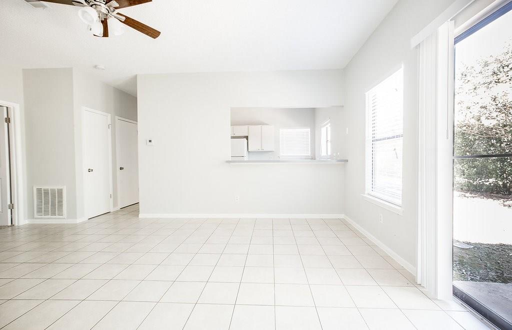 3707 Buffalo Springs Trail, Unit 301 Georgetown, TX 78628 - Photo 2 of 15 Unfurnished living room featuring a ceiling fan and light tile patterned floors