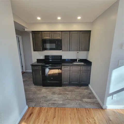 a kitchen with stainless steel appliances wooden cabinets and granite counter tops