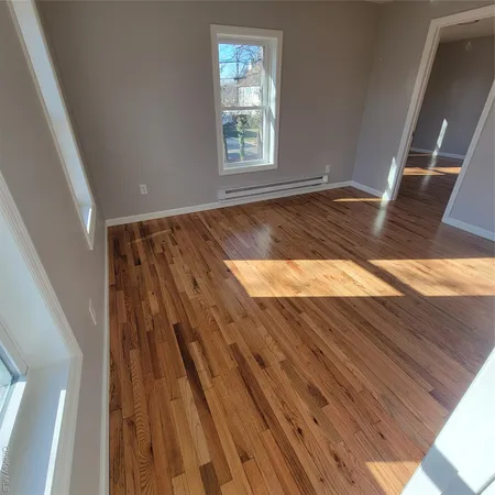 a view of wooden floor in an empty room