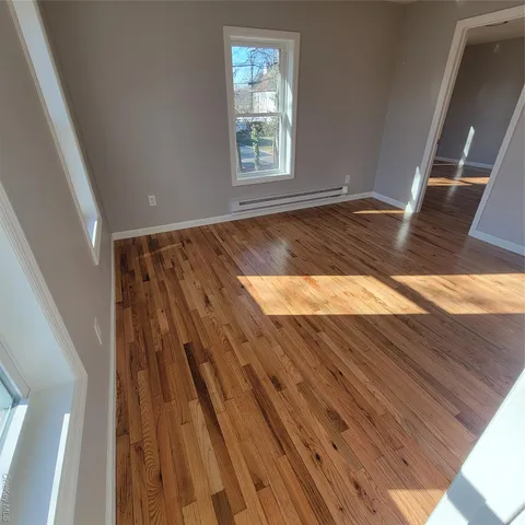 a view of wooden floor in an empty room