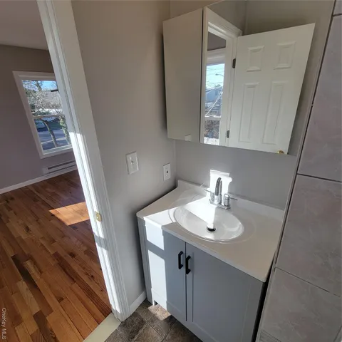a bathroom with a sink a mirror and vanity