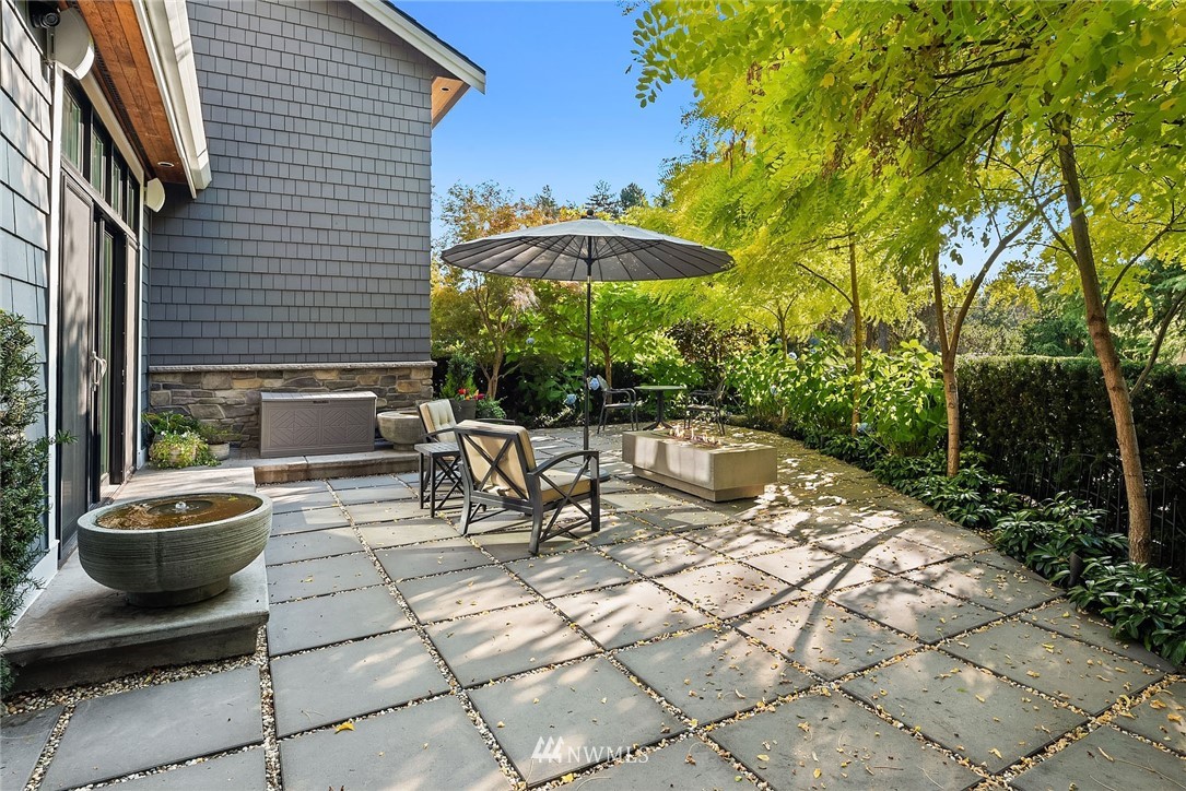 3112 Hunts Point Circle Hunts Point, WA 98004 - Photo 20 of 40 a view of a patio with table and chairs potted plants and barbeque grill