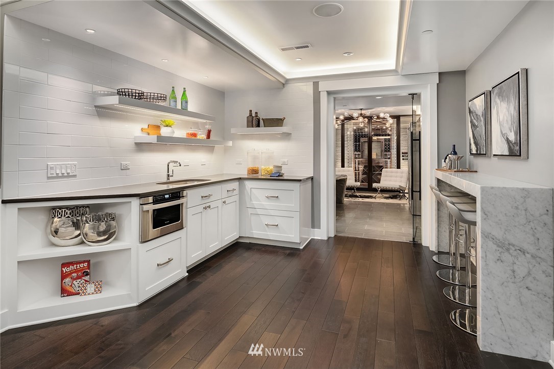 3112 Hunts Point Circle Hunts Point, WA 98004 - Photo 29 of 40 a kitchen with stainless steel appliances granite countertop a stove a sink and a refrigerator
