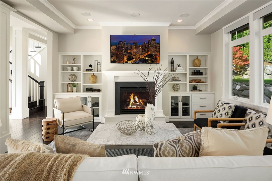 3112 Hunts Point Circle Hunts Point, WA 98004 - Photo 4 of 40 a living room with furniture a fireplace and a flat screen tv